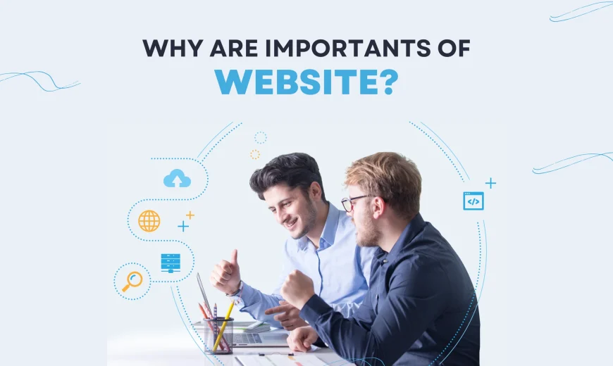 two men sitting at a table looking at a laptop